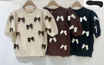 Zwart truitje met offwhite strikken